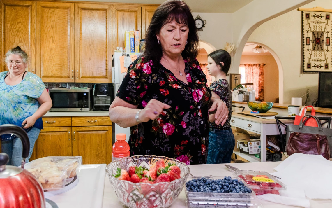 A family prepares a snack of fresh fruit