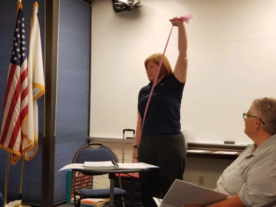 Dr. Cathy Martinez, demonstrates the use of resistance bands to her program participants.