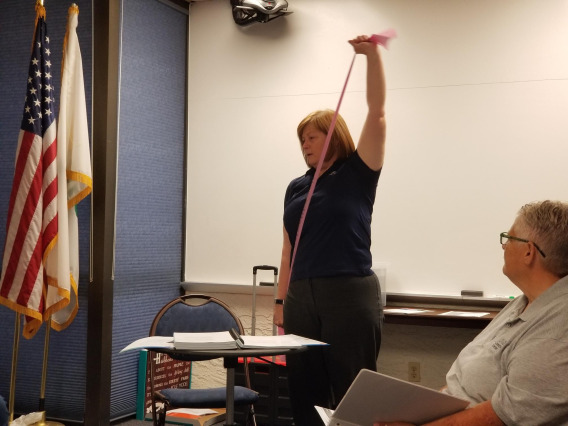 Dr. Cathy Martinez, demonstrates the use of resistance bands to her program participants.